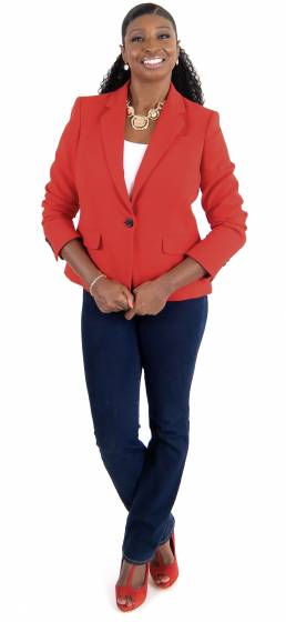 Lisza Rawlins of Fireset in red jacket standing holding jacket